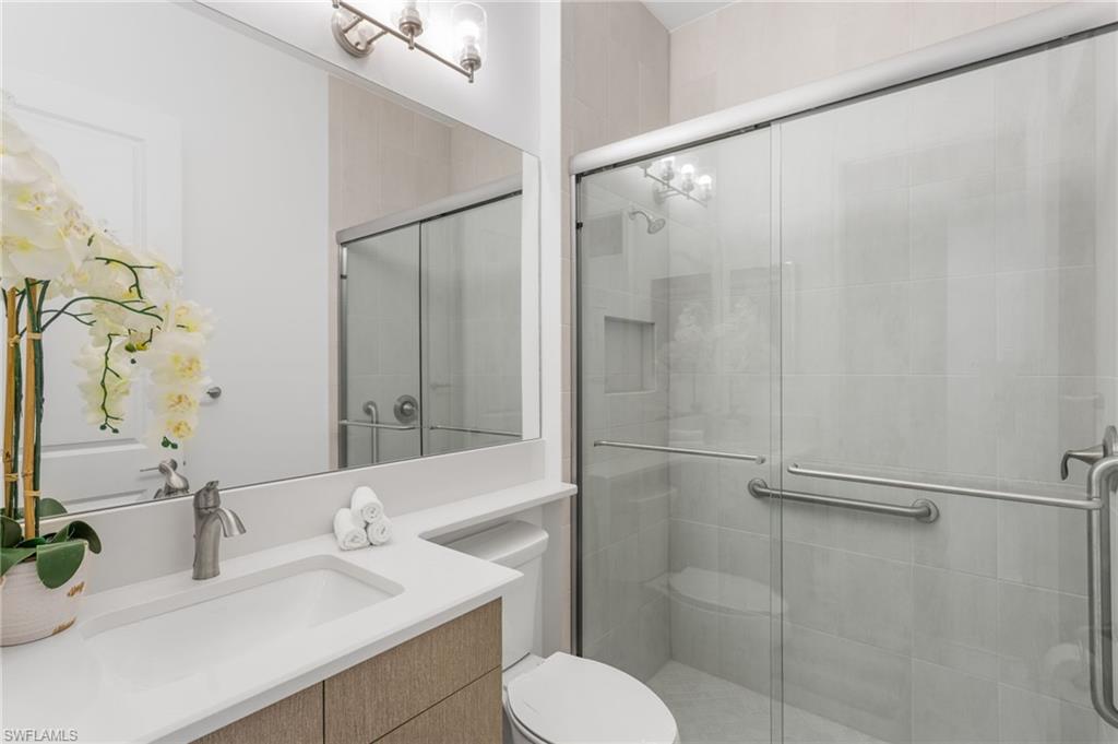 12370 Purple Ficus Way Naples, FL 34120 - Photo 23 of 50 Bathroom with vanity and a shower stall