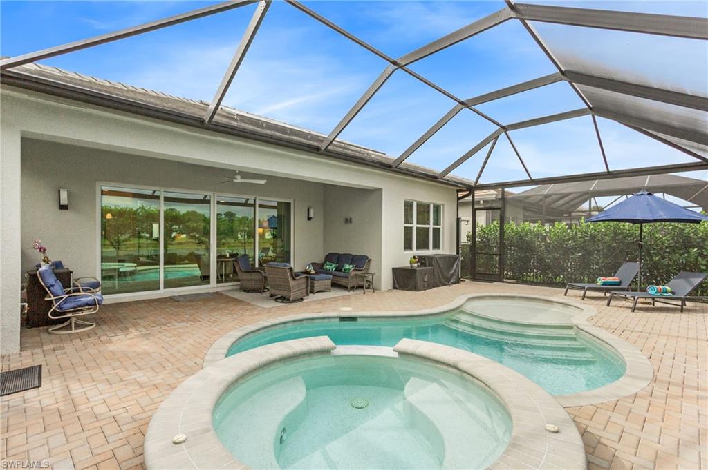 12370 Purple Ficus Way Naples, FL 34120 - Photo 30 of 50 Relaxing pool / spa with a sunroom, outdoor lounge area, a lanai, and a patio area