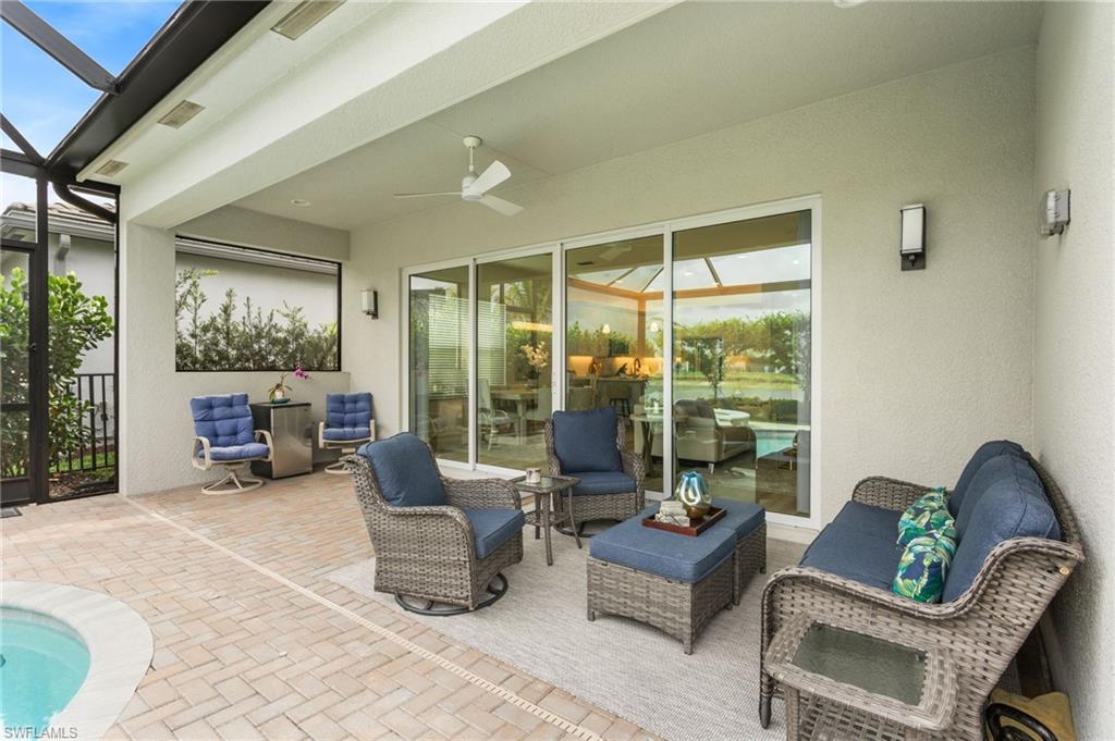 12370 Purple Ficus Way Naples, FL 34120 - Photo 31 of 50 View of patio / terrace with glass enclosure, a ceiling fan, an outdoor pool, a sunroom, and an outdoor hangout area