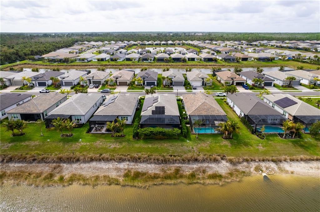 12370 Purple Ficus Way Naples, FL 34120 - Photo 38 of 50 Aerial view of residential area with a nearby body of water
