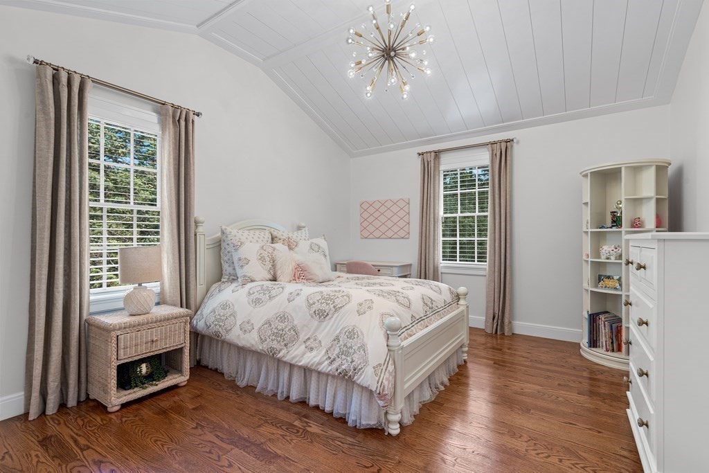 34 Willow Road Wellesley, MA 02482 - Photo 16 of 26 a bedroom with a bed and a chandelier