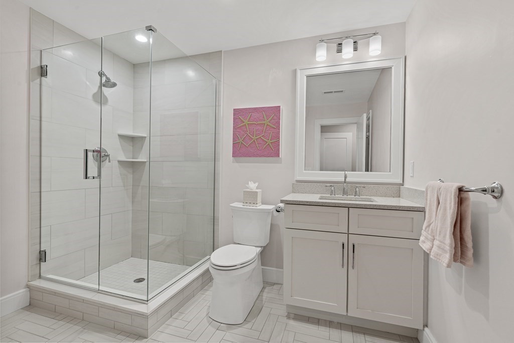 34 Willow Road Wellesley, MA 02482 - Photo 17 of 26 a bathroom with a sink a toilet and shower