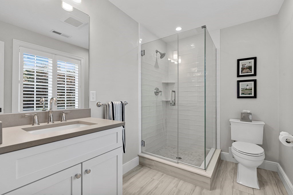 34 Willow Road Wellesley, MA 02482 - Photo 19 of 26 a bathroom with a granite countertop sink a toilet and shower