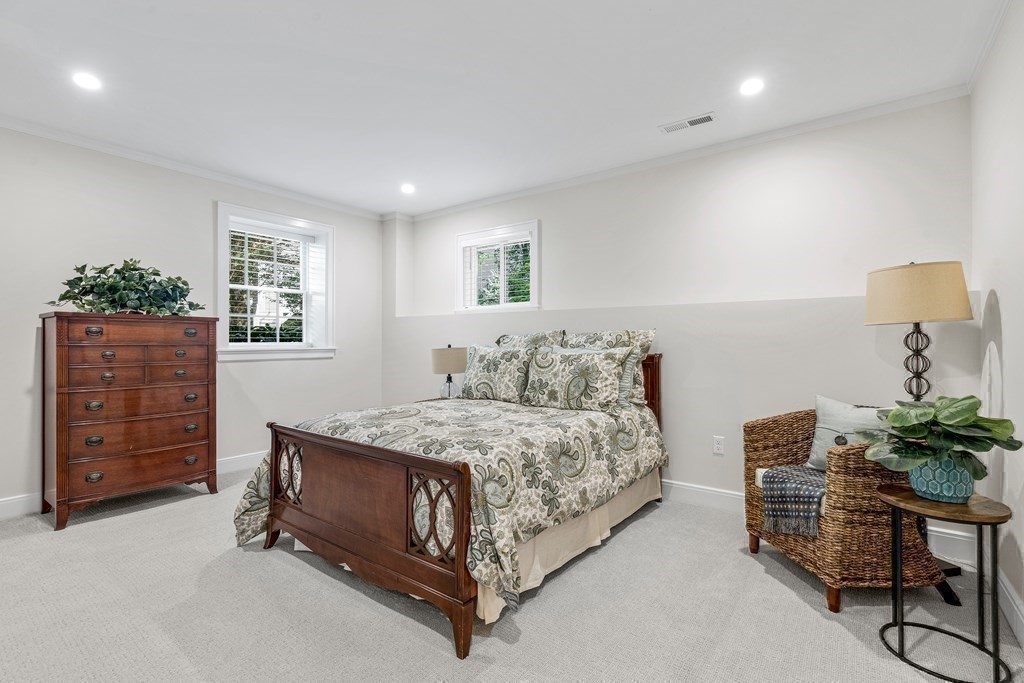 34 Willow Road Wellesley, MA 02482 - Photo 24 of 26 a spacious bedroom with a bed and a dresser