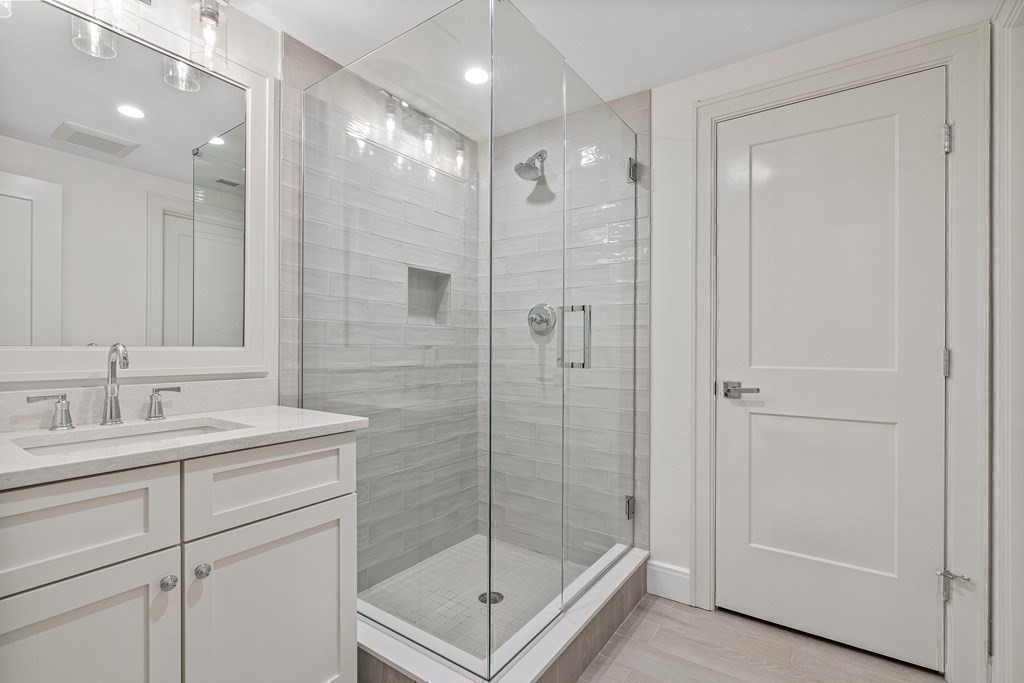 34 Willow Road Wellesley, MA 02482 - Photo 25 of 26 a bathroom with a shower sink and mirror