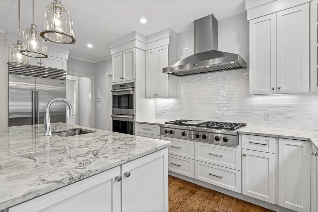 34 Willow Road Wellesley, MA 02482 - Photo 6 of 26 a kitchen with stainless steel appliances granite countertop a stove a sink and a refrigerator