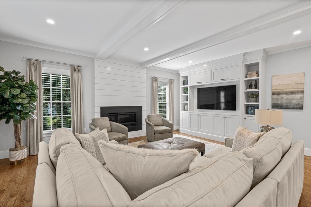 34 Willow Road Wellesley, MA 02482 - Photo 10 of 26 a living room with furniture a flat screen tv and a fireplace