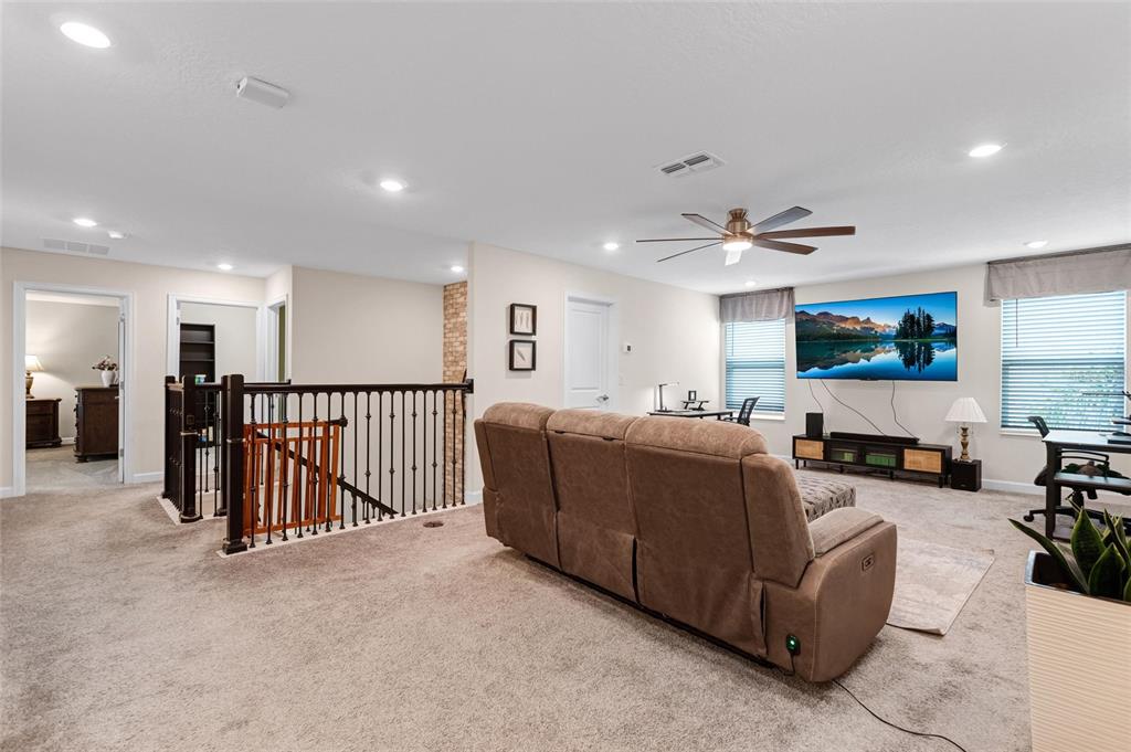 1089 Blackwolf Run Road Davenport, FL 33896 - Photo 25 of 82 a living room with furniture and a flat screen tv