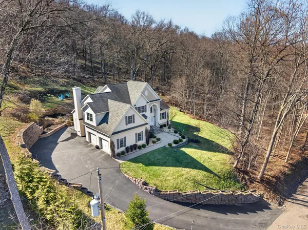 an aerial view of a house with a yard basket ball court and outdoor seating