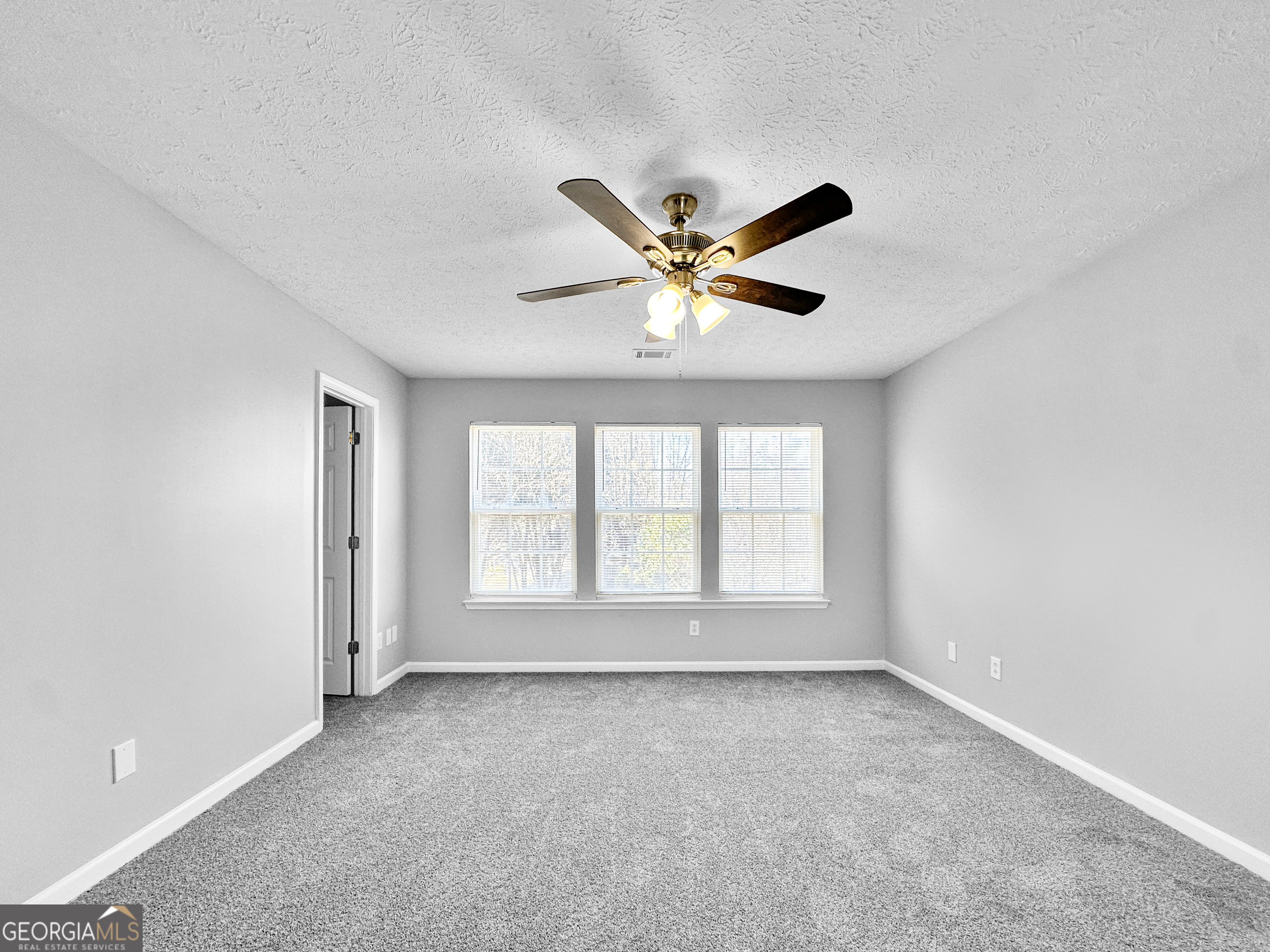 4045 Springvale Way McDonough, GA 30252 - Photo 10 of 18 an empty room with a window and a fan