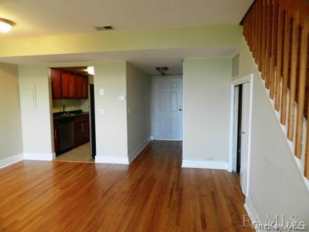 Unfurnished living room featuring hardwood / wood-style floors