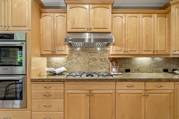 a kitchen with stainless steel appliances granite countertop white cabinets and a sink