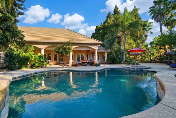 a view of a swimming pool with chairs