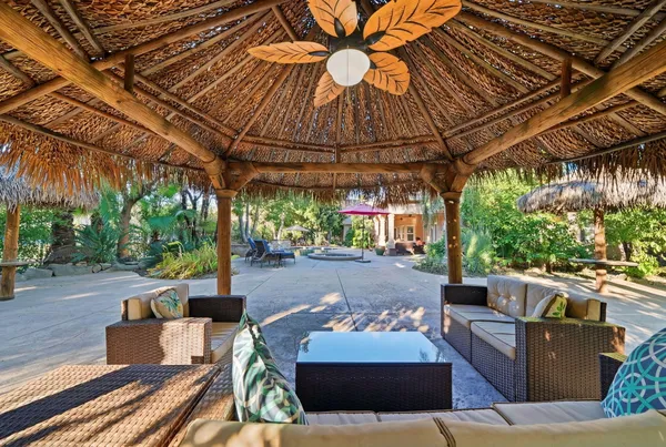 a view of patio with couches and pool