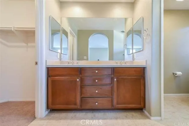a bathroom with a granite countertop sink vanity and mirror