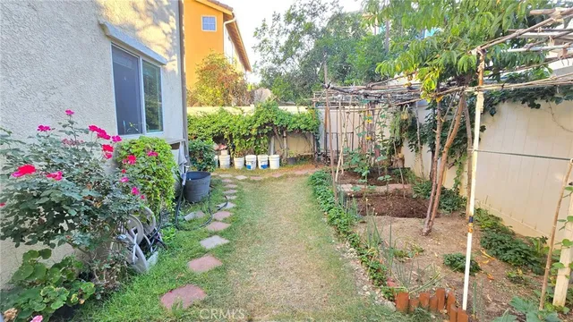 a backyard of a house with fountain and outdoor seating
