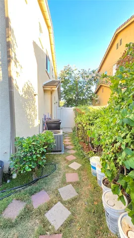 a view of a backyard with plants and a patio