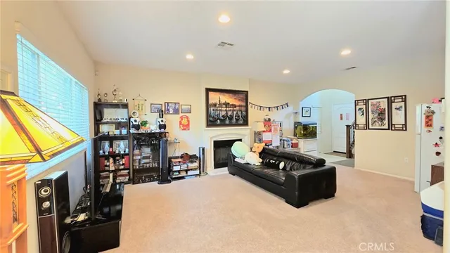 a living room with fireplace furniture and a flat screen tv