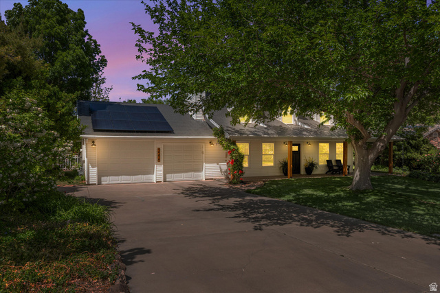 246 West Mount Charm Road Toquerville, UT 84774 - Photo 59 of 70 View of front of property with solar panels, driveway, a front lawn, an attached garage, and roof with shingles