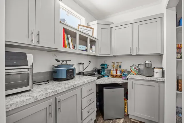 a kitchen with granite countertop a sink stainless steel appliances and cabinets