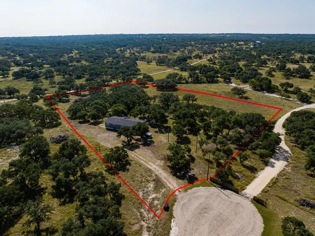 an aerial view of residential houses with outdoor space