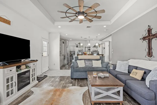 a living room with furniture and a flat screen tv