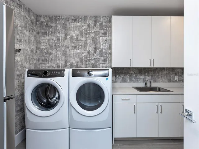 a bedroom with a bed and glass walk in closet