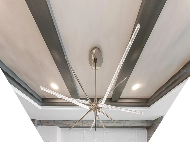 a living room with furniture and floor to ceiling window