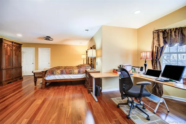 a spacious bedroom with a bed and a large window