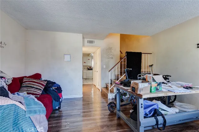 a view of a workspace with furniture and wooden floor