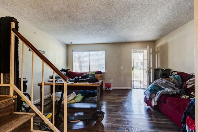 a living room with furniture and stairs
