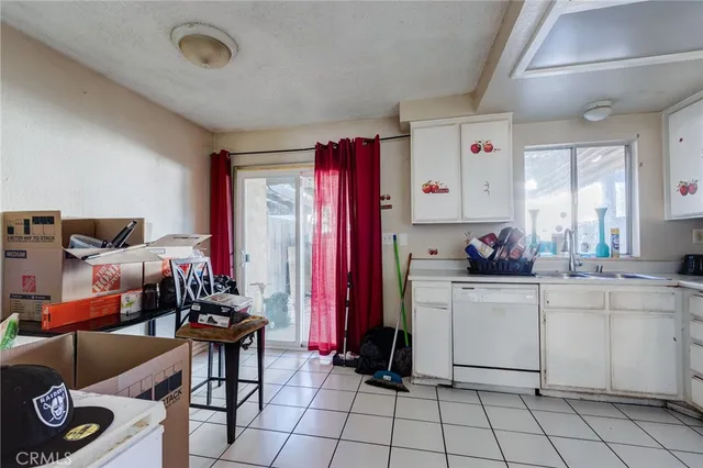a kitchen that has a lot of cabinets in it and appliances