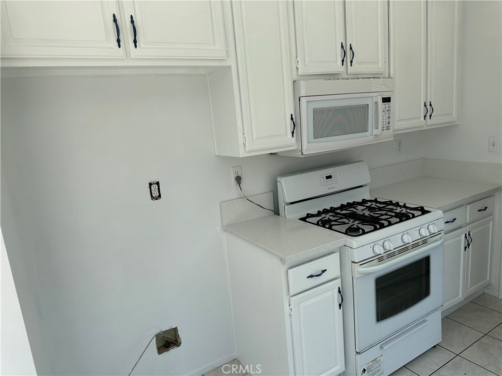 2342 Fitzgerald Road Simi Valley, CA 93065 - Photo 12 of 27 a white stove top oven sitting inside of a kitchen