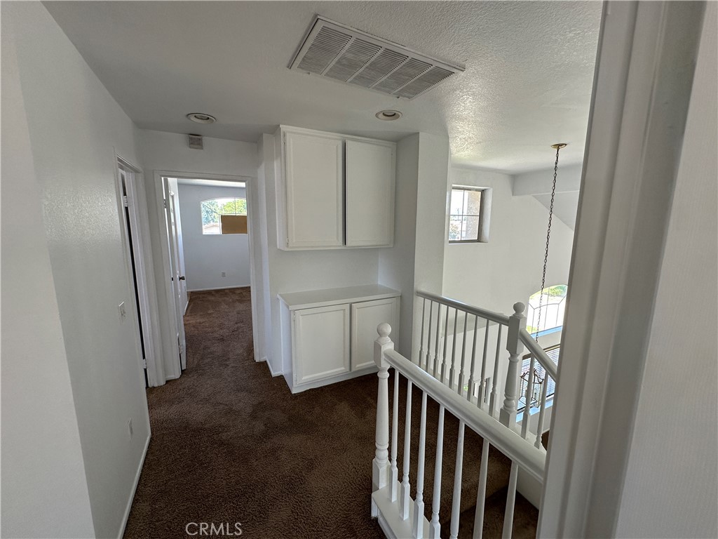 2342 Fitzgerald Road Simi Valley, CA 93065 - Photo 17 of 27 a view of a hallway with wooden floor and windows