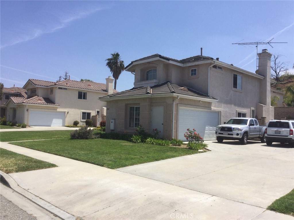 2342 Fitzgerald Road Simi Valley, CA 93065 - Photo 2 of 27 a car parked in front of a white house
