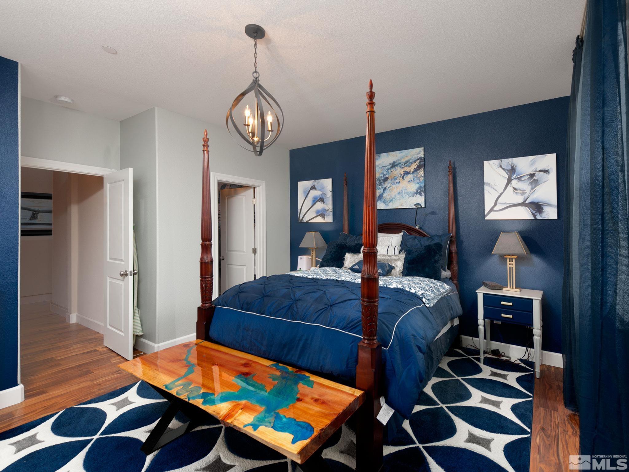 2025 Wind Ranch Road, Unit C Reno, NV 89521 - Photo 13 of 31 a bedroom with a bed and wooden floor