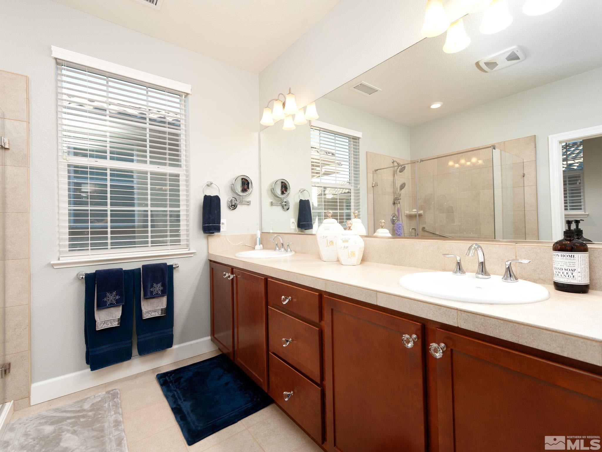 2025 Wind Ranch Road, Unit C Reno, NV 89521 - Photo 14 of 31 a spacious bathroom with double vanity sink a mirror a lamp and window