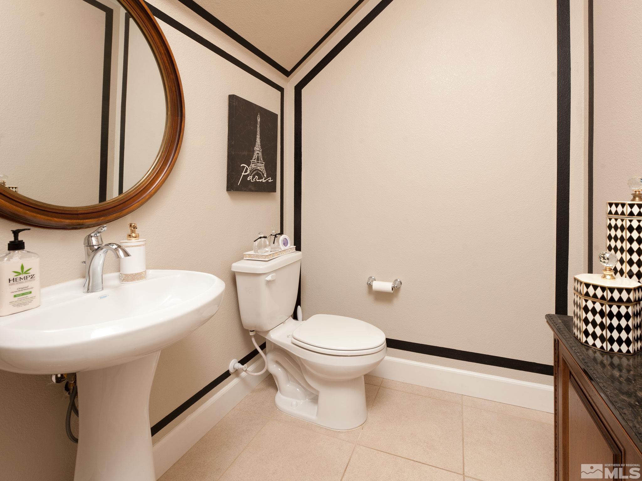 2025 Wind Ranch Road, Unit C Reno, NV 89521 - Photo 23 of 31 a white toilet sitting next to a bathroom sink