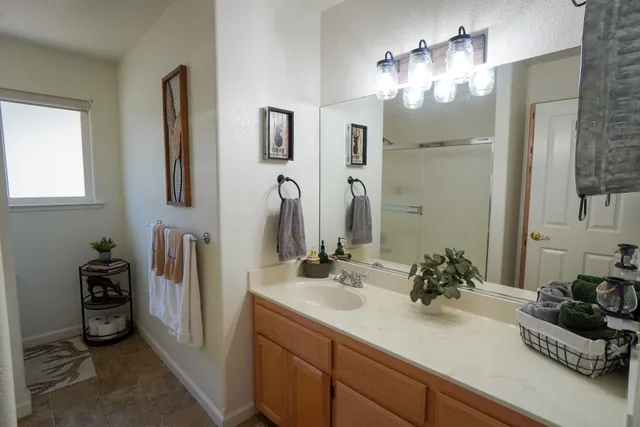 a bathroom with sink a mirror and shower