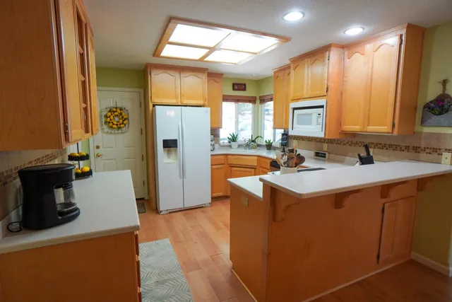 a kitchen with stainless steel appliances a sink stove and refrigerator