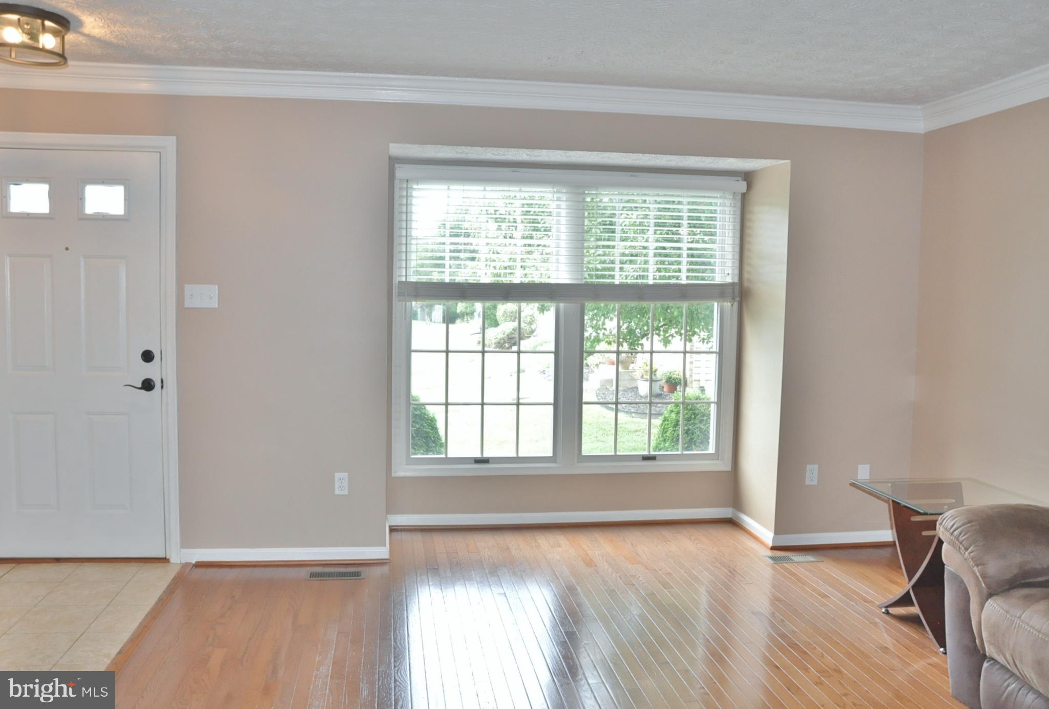 21 Margery Court Nottingham, MD 21236 - Photo 17 of 67 a view of an empty room with a window and wooden floor