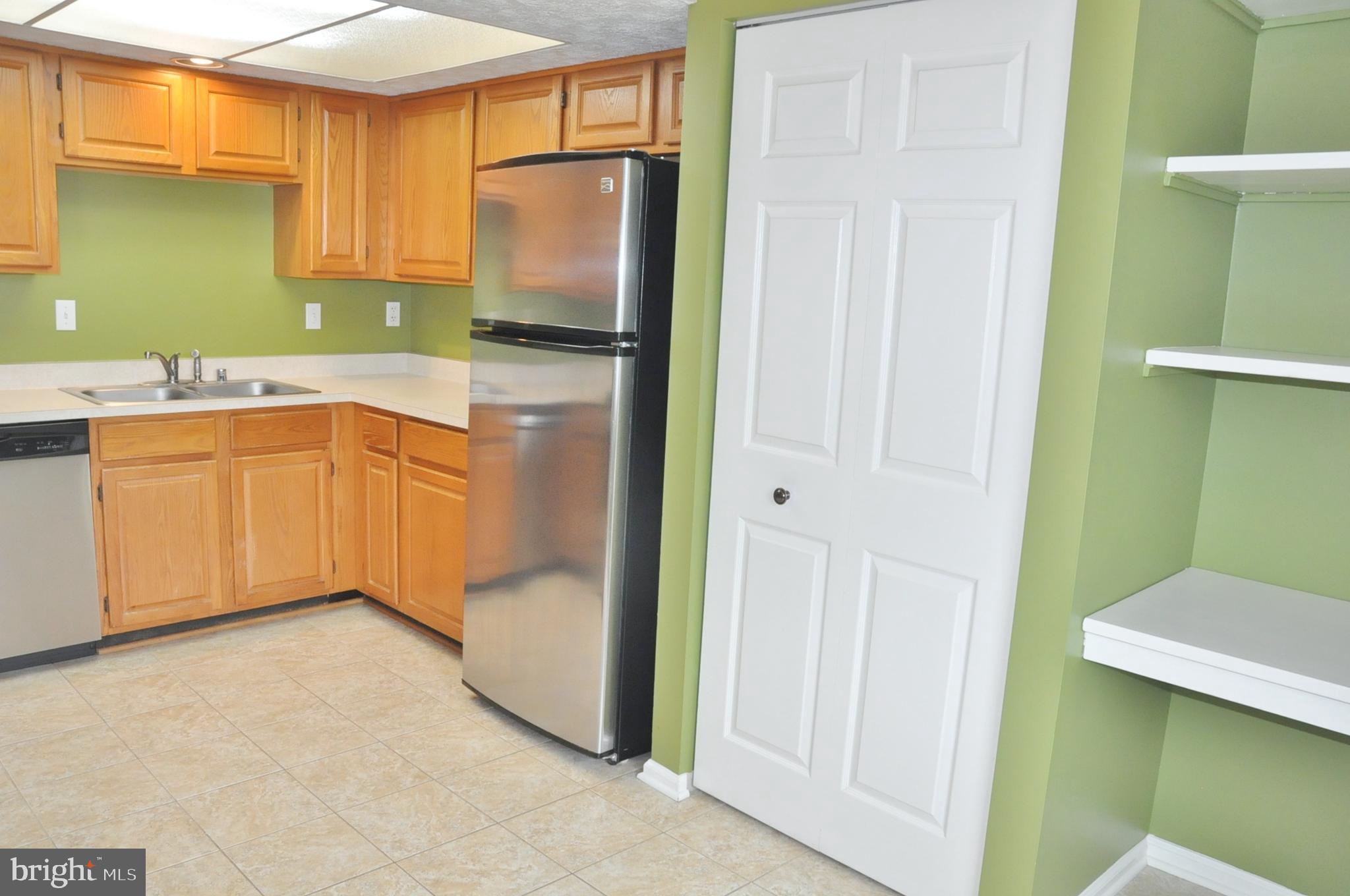 21 Margery Court Nottingham, MD 21236 - Photo 27 of 67 a kitchen with a refrigerator and a sink