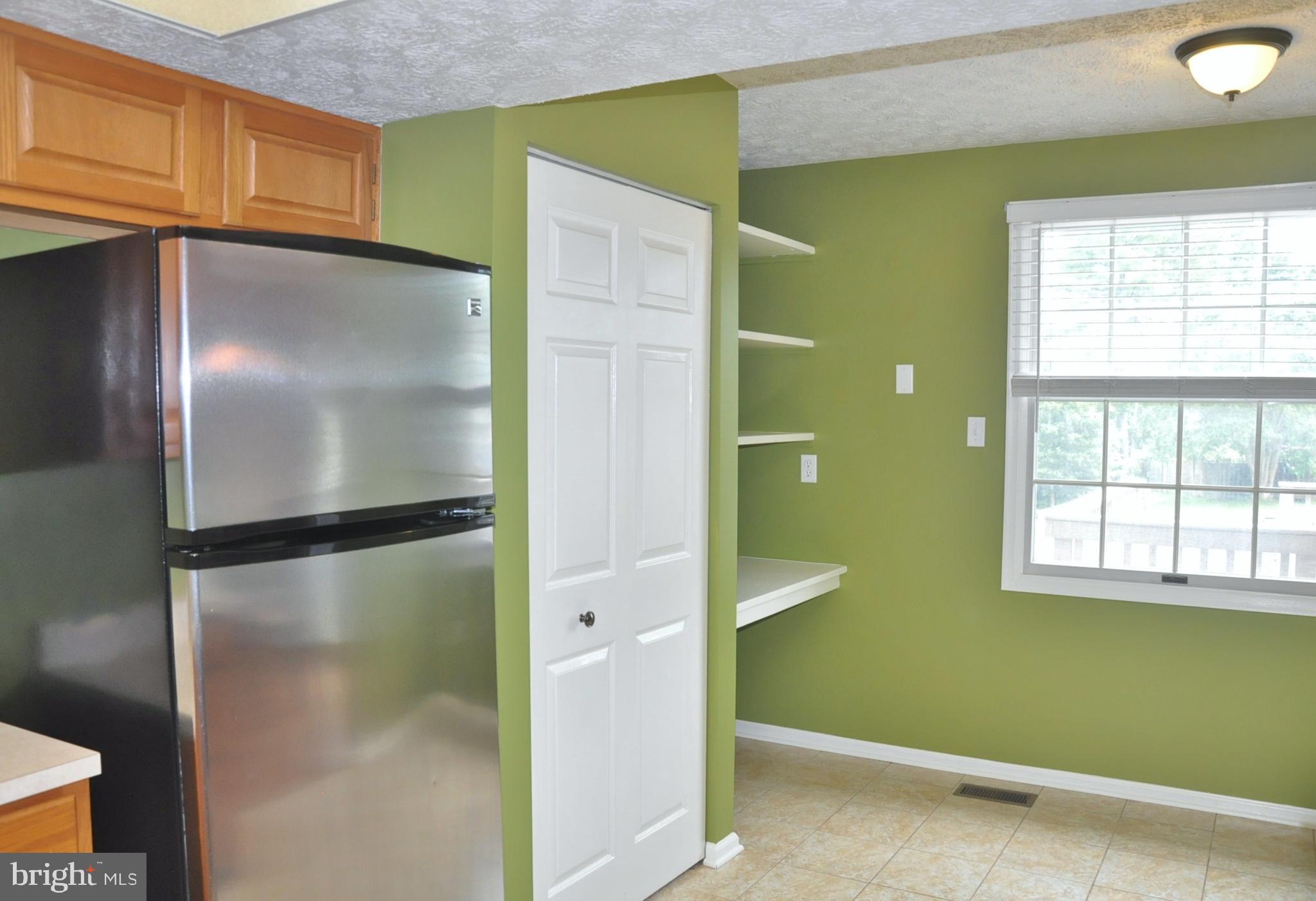 21 Margery Court Nottingham, MD 21236 - Photo 30 of 67 a view of a kitchen with a refrigerator and window