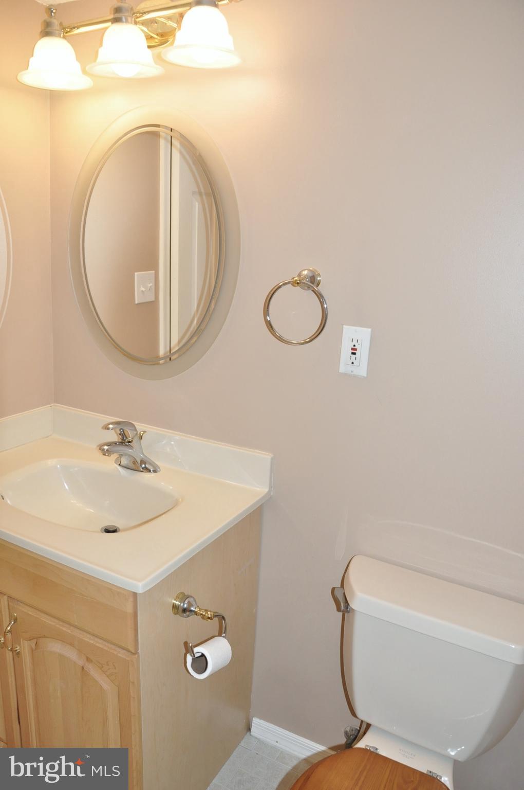 21 Margery Court Nottingham, MD 21236 - Photo 51 of 67 a bathroom with a sink a mirror and a toilet