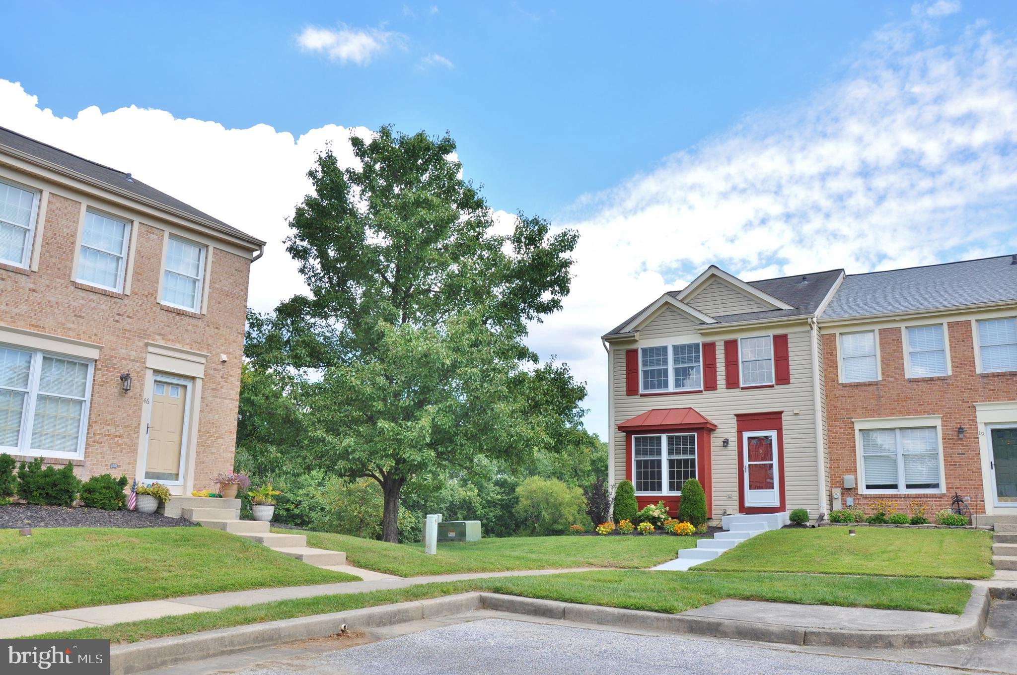 21 Margery Court Nottingham, MD 21236 - Photo 55 of 67 a view of a brick house next to a yard with big trees