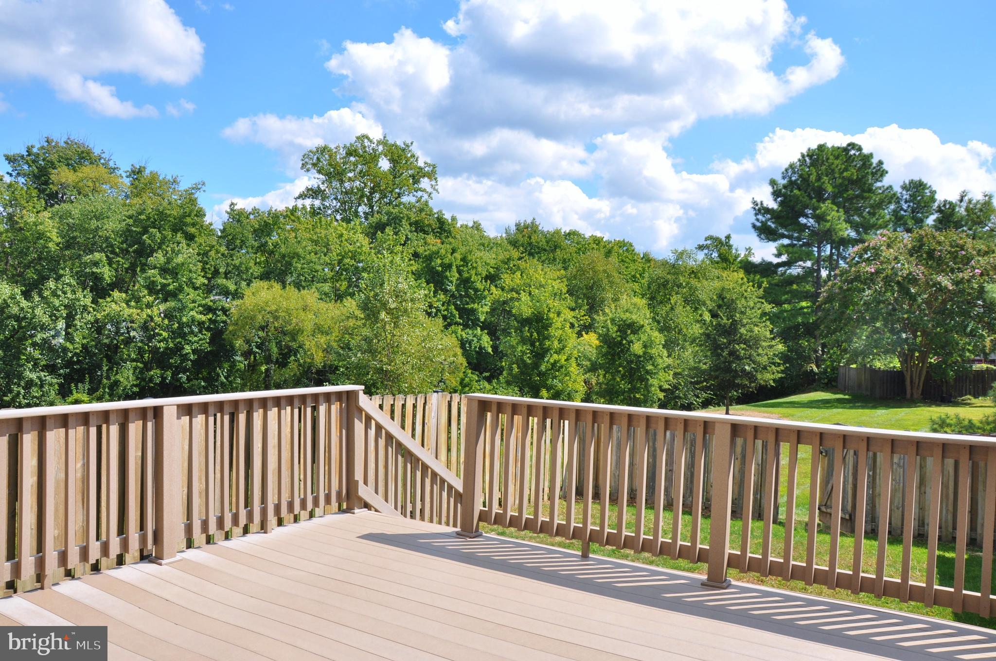 21 Margery Court Nottingham, MD 21236 - Photo 6 of 67 a balcony with wooden floor and trees in the back