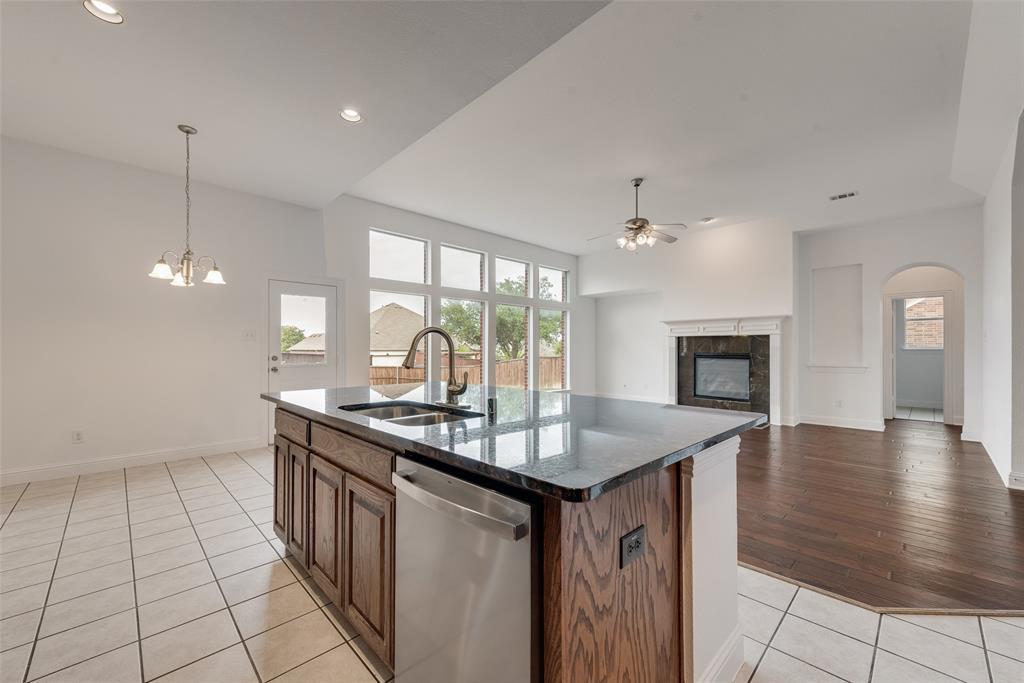 413 Kearsarge Street DeSoto, TX 75115 - Photo 13 of 33 a kitchen with sink cabinets and window
