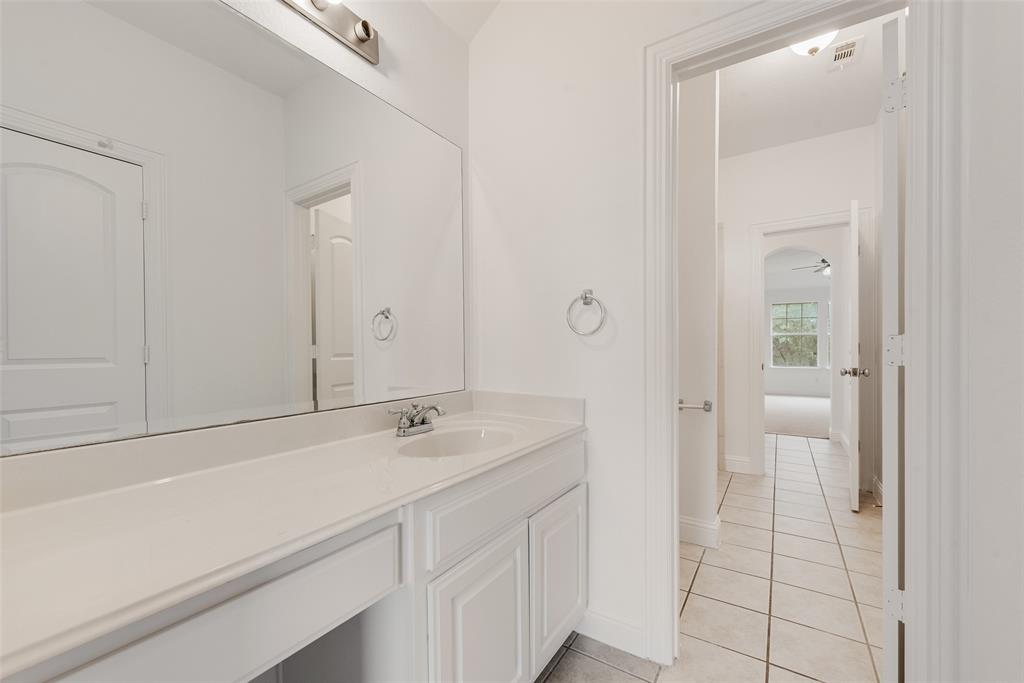 413 Kearsarge Street DeSoto, TX 75115 - Photo 24 of 33 a bathroom with a sink and a mirror