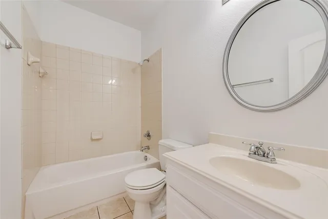 a bathroom with a granite countertop sink toilet and a mirror