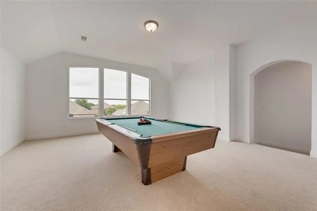 an outdoor space with pool table and windows